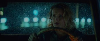 Movie still from “Troll” (2022), directed by Roar Uthaug – A woman sitting in the drivers seat of a car at night; Close Up shot, Low angle