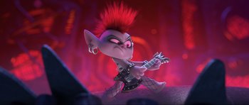 Movie still from “Trolls World Tour” (2020), directed by Walt Dohrn – A troll with a red mohawk playing a guitar; Medium shot, High angle