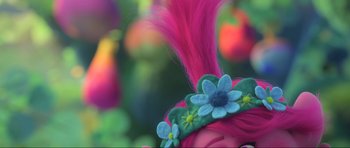 Movie still from “Trolls World Tour” (2020), directed by Walt Dohrn – A pink troll wig with flowers on it; Extreme Close Up shot, Over the shoulder angle