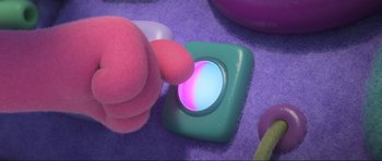 Movie still from “Trolls World Tour” (2020), directed by Walt Dohrn – A person touching a button on a purple surface; Extreme Close Up shot, High angle
