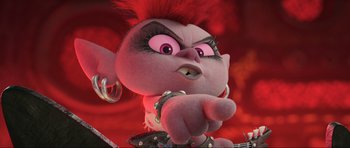 Movie still from “Trolls World Tour” (2020), directed by Walt Dohrn – A pink stuffed animal with a red mohawk and pink eyes; Close Up shot, High angle