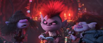Movie still from “Trolls World Tour” (2020), directed by Walt Dohrn – A troll doll with a red mohawk hair style; Medium shot, Over the shoulder angle