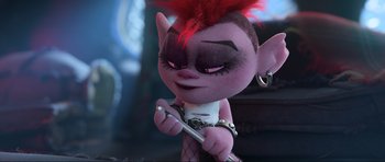 Movie still from “Trolls World Tour” (2020), directed by Walt Dohrn – A troll doll is holding a cell phone in her hands; Close Up shot, High angle