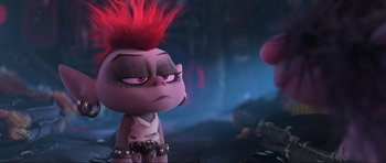 Movie still from “Trolls World Tour” (2020), directed by Walt Dohrn – A stuffed animal that has red hair and a pink mohawk; Close Up shot, Over the shoulder angle