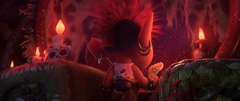 Movie still from “Trolls World Tour” (2020), directed by Walt Dohrn – A stuffed animal with a mohawk is sitting in a room; Medium shot, Over the shoulder angle