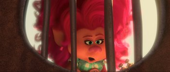 Movie still from “Trolls World Tour” (2020), directed by Walt Dohrn – A pink haired troll looking through bars of a jail cell; Close Up shot, Over the shoulder angle