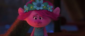Movie still from “Trolls World Tour” (2020), directed by Walt Dohrn – A pink haired girl with a flower crown on her head; Close Up shot, Over the shoulder angle