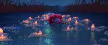 Movie still from “Trolls World Tour” (2020), directed by Walt Dohrn – A pink stuffed animal laying in the water next to candles; Wide shot, High angle