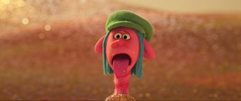 Movie still from “Trolls World Tour” (2020), directed by Walt Dohrn – A pink doll with a green hat and long blue hair; Close Up shot, Low angle