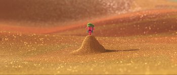 Movie still from “Trolls World Tour” (2020), directed by Walt Dohrn – A toy character is standing in a pile of sand; Extreme Wide shot, High angle