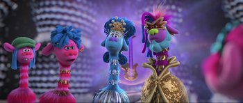 Movie still from “Trolls World Tour” (2020), directed by Walt Dohrn – A group of three cartoon characters standing next to each other; Close Up shot, Low angle