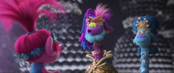 Movie still from “Trolls World Tour” (2020), directed by Walt Dohrn – A troll doll is sitting on top of a ball; Close Up shot, Over the shoulder angle