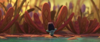 Movie still from “Trolls World Tour” (2020), directed by Walt Dohrn – A troll doll sitting in front of some leaves on the ground; Extreme Wide shot, High angle