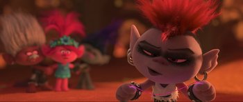 Movie still from “Trolls World Tour” (2020), directed by Walt Dohrn – A stuffed animal with a red mohawk; Close Up shot, Over the shoulder angle