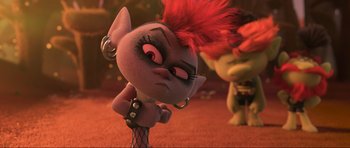 Movie still from “Trolls World Tour” (2020), directed by Walt Dohrn – A stuffed animal that has a red mohawk on top of its head; Medium shot, Over the shoulder angle