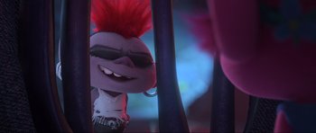 Movie still from “Trolls World Tour” (2020), directed by Walt Dohrn – A stuffed animal with a red mohawk; Close Up shot, Over the shoulder angle
