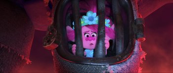 Movie still from “Trolls World Tour” (2020), directed by Walt Dohrn – A troll doll is in a cage with a flower on its head; Close Up shot, Over the shoulder angle