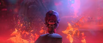 Movie still from “Trolls World Tour” (2020), directed by Walt Dohrn – A doll is standing on top of a pile of rocks; Wide shot, Low angle