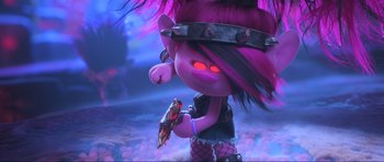 Movie still from “Trolls World Tour” (2020), directed by Walt Dohrn – A troll holding a piece of pizza in her hand; Medium shot, High angle