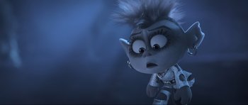 Movie still from “Trolls World Tour” (2020), directed by Walt Dohrn – A stuffed animal with a chain around it's neck; Medium shot, High angle