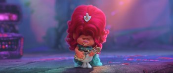 Movie still from “Trolls World Tour” (2020), directed by Walt Dohrn – A troll doll with a pink hair holding a guitar; Medium shot, High angle
