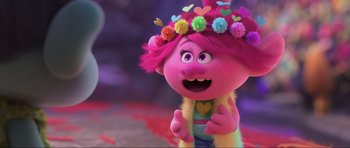 Movie still from “Trolls World Tour” (2020), directed by Walt Dohrn – A pink haired girl is wearing a flower crown; Close Up shot, Over the shoulder angle