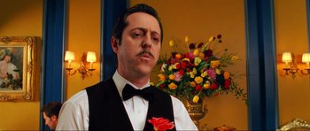 Movie still from “Tropic Thunder” (2008), directed by Ben Stiller – A person wearing a suit and tie; Close Up shot, Low angle