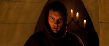 Movie still from “Tropic Thunder” (2008), directed by Ben Stiller – A man in a hooded robe stares into the camera; Close Up shot, Low angle