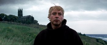 Movie still from “Tropic Thunder” (2008), directed by Ben Stiller – A person wearing a hooded sweatshirt; Close Up shot, Low angle