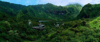 Movie still from “Tropic Thunder” (2008), directed by Ben Stiller – A group of helicopters flying over a lush green hillside; Extreme Wide shot, Low angle