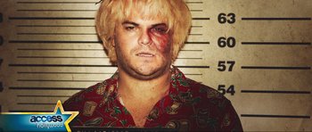 Movie still from “Tropic Thunder” (2008), directed by Ben Stiller – A mugshot of a man with a bruised face; Close Up shot, Overhead angle