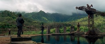 Movie still from “Tropic Thunder” (2008), directed by Ben Stiller – A man standing next to a body of water; Extreme Wide shot, High angle