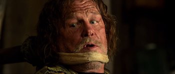 Movie still from “Tropic Thunder” (2008), directed by Ben Stiller – A person with a bandage on his mouth; Close Up shot, Over the shoulder angle
