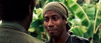 Movie still from “Tropic Thunder” (2008), directed by Ben Stiller – A person wearing a head scarf; Close Up shot, Over the shoulder angle