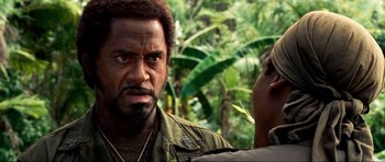 Movie still from “Tropic Thunder” (2008), directed by Ben Stiller – A man with a beard is looking at another man with a beard; Close Up shot, Over the shoulder angle
