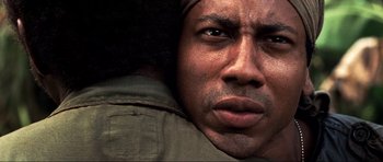 Movie still from “Tropic Thunder” (2008), directed by Ben Stiller – A man's face in a dark room; Extreme Close Up shot, Over the shoulder angle