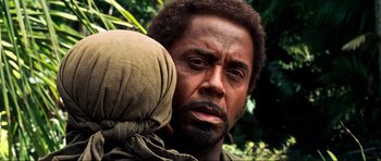 Movie still from “Tropic Thunder” (2008), directed by Ben Stiller – A man holding a baby in his arms; Close Up shot, Over the shoulder angle