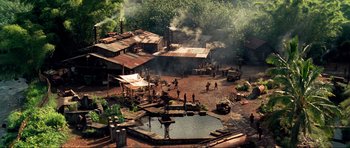 Movie still from “Tropic Thunder” (2008), directed by Ben Stiller – A group of people standing next to a body of water; Extreme Wide shot, High angle