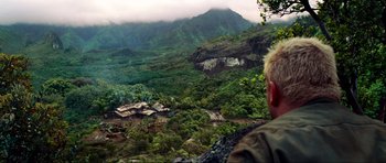 Movie still from “Tropic Thunder” (2008), directed by Ben Stiller – A man standing on a hill looking over a valley; Extreme Wide shot, Over the shoulder angle