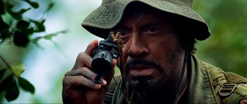 Movie still from “Tropic Thunder” (2008), directed by Ben Stiller – A person holding a camera; Close Up shot, Over the shoulder angle