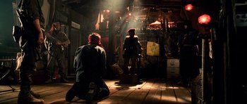 Movie still from “Tropic Thunder” (2008), directed by Ben Stiller – Two people sitting on the ground in a room; Wide shot, Low angle