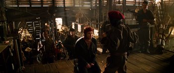 Movie still from “Tropic Thunder” (2008), directed by Ben Stiller – A group of people sitting in a room; Wide shot, Over the shoulder angle