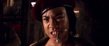 Movie still from “Tropic Thunder” (2008), directed by Ben Stiller – A young man wearing a red beret smoking a cigarette; Close Up shot, Low angle