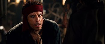 Movie still from “Tropic Thunder” (2008), directed by Ben Stiller – A person wearing a headband; Close Up shot, Over the shoulder angle
