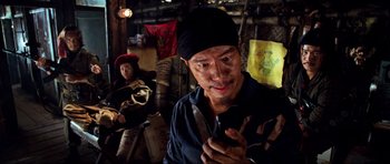 Movie still from “Tropic Thunder” (2008), directed by Ben Stiller – A man holding a pair of scissors in his hand; Close Up shot, Over the shoulder angle