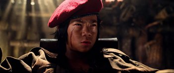 Movie still from “Tropic Thunder” (2008), directed by Ben Stiller – A young man in a red beret with blood on his face; Close Up shot, Low angle