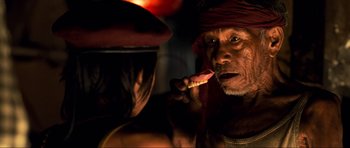Movie still from “Tropic Thunder” (2008), directed by Ben Stiller – An older man is brushing his teeth in front of a younger man; Close Up shot, Over the shoulder angle