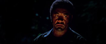 Movie still from “Tropic Thunder” (2008), directed by Ben Stiller – A person wearing a black shirt; Close Up shot, Low angle