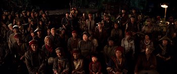 Movie still from “Tropic Thunder” (2008), directed by Ben Stiller – A group of men and women sitting on the ground; Wide shot, High angle
