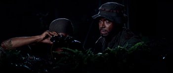 Movie still from “Tropic Thunder” (2008), directed by Ben Stiller – A man and a woman looking through binoculars; Close Up shot, Over the shoulder angle